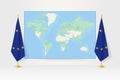 World Map between two hanging flags of European Union flag stand Royalty Free Stock Photo