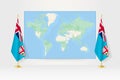 World Map between two hanging flags of Fiji flag stand Royalty Free Stock Photo