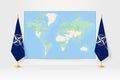 World Map between two hanging flags of Nato flag stand Royalty Free Stock Photo