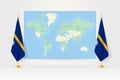 World Map between two hanging flags of Nauru flag stand Royalty Free Stock Photo