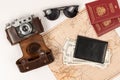 World map, two passports, money in a black leather wallet, an old film camera in a leather case and sunglasses on a white t Royalty Free Stock Photo