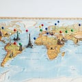 Yellow blue and green pins are scattered across continents indicating Royalty Free Stock Photo