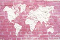 World map of white cement plaster on a pink brick background. Pi