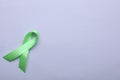 World Mental Health Day. Green ribbon on color background, top view with space for text Royalty Free Stock Photo