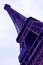 World most famous landmark Eiffel tower under purple ultra violet light in Paris France during sunrise no people in picture