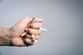 World No Tobacco Day, May 31. STOP Smoking. Close up Man hand crushing and destroying cigarettes on gray background