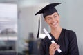 The world is now her oyster. Portrait of a young woman in a graduation gown holding a diploma. Royalty Free Stock Photo