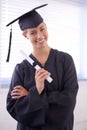 The world is now her oyster. a young woman in a graduation gown holding a diploma. Royalty Free Stock Photo