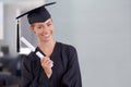 The world is now her oyster. a young woman in a graduation gown holding up a diploma. Royalty Free Stock Photo