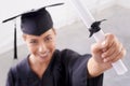 The world is now her oyster. a young woman in a graduation gown holding up her diploma. Royalty Free Stock Photo