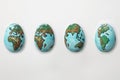 The World painted on eggs showing rotation cycle of the Planet E