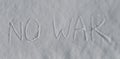 We are for world peace. White snow and pleading words written by child. The inscription on snow by hand in English - No War Royalty Free Stock Photo