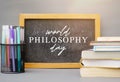 World Philosophy Day. Stack of books with pens and lettering on white background. Royalty Free Stock Photo