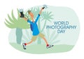 World Photographer`s Day. A cheerful guy photographer takes pictures of nature with two cameras