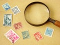 World postage stamps and magnifying glass