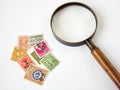 World postage stamps and magnifying glass