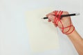 World Press Freedom Day concept. Hand holding pen with red rope.
