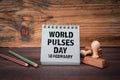 World Pulses Day 10. February. Cardboard notepad on wooden texture table