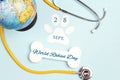 World Rabies Day background with globe, stethoscope, symbolic bone and paw