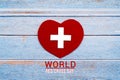 World Red Cross day. Red heart on wooden table background texture