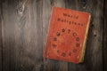 World religions book with symbols on wooden table top view