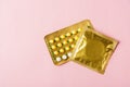 Condom in wrapper pack and contraceptive pills blister Royalty Free Stock Photo