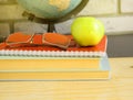 World teacher's Day at school. Still life with books, globe, Apple, glasses, sunlight