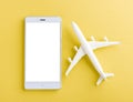 World Tourism Day, Top view flat lay of minimal toy model plane, airplane, and smartphone blank screen, studio shot isolated Royalty Free Stock Photo
