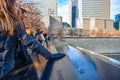 World Trade Center Memorial at Ground Zero, Manhattan. A girl, putting his hand on the bronze parapet. Royalty Free Stock Photo