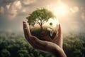 World and tree in human hand on nature background.