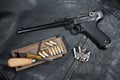 World War I period german army handgun Parabellum with ammuniotions and accessories on black leather jacket