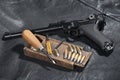World War I period german army handgun Parabellum with ammuniotions and accessories on black leather jacket
