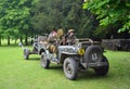 World War 2 Jeep with men dressed as World War 2 Soldiers, towing Gun.