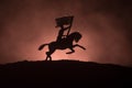 World war officer (or warrior) rider on horse with a sword ready to fight and soldiers on a dark foggy toned background. Battle sc Royalty Free Stock Photo