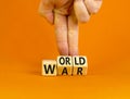 World war symbol. Concept words World war on wooden cubes. Businessman hand. Beautiful orange table orange background. Business Royalty Free Stock Photo