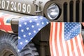 A world war two jeep with stars and stripes bunting wrapped around it Royalty Free Stock Photo