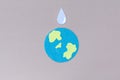 World Water Day. Carved out of felt is the symbol of the planet Earth and a drop of water. Gray background. Copy space.