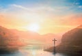 Surrender concept: Silhouette of crucifix cross on mountain at sunset time with holy and light background Royalty Free Stock Photo