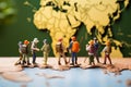 Worldly exploration Miniature figures walking on a map, travel concept