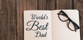 Worlds best dad message written on notebook Royalty Free Stock Photo