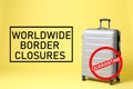 Worldwide border closures through quarantine during coronavirus outbreak. Suitcase and prohibition sign on background