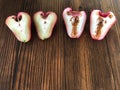 Worm in apple rose. Half an Apple Rose on the wooden table , sweet and sour fruit. Healthy and diet fruit. Royalty Free Stock Photo