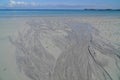 Worm casts and rivulets on sand beach Royalty Free Stock Photo