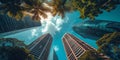 Worm's-eye view of skyscrapers towering over tropical palms against a clear blue sky Royalty Free Stock Photo