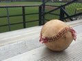 Worn baseball in corner of bleachers