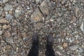 Worn boots on rough rocky footpath