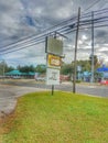 Worn commercial street signage on pole grass frontage Tampa Florida