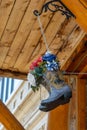 Hanging Cowboy Boots with Wyoming bucking bronco with rider logo, filled with flowers hanging from ceiling