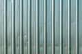 Worn damaged corrugated metal sheet texture
