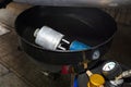 Worn diesel fuel filter, lying in the used car fluid container.